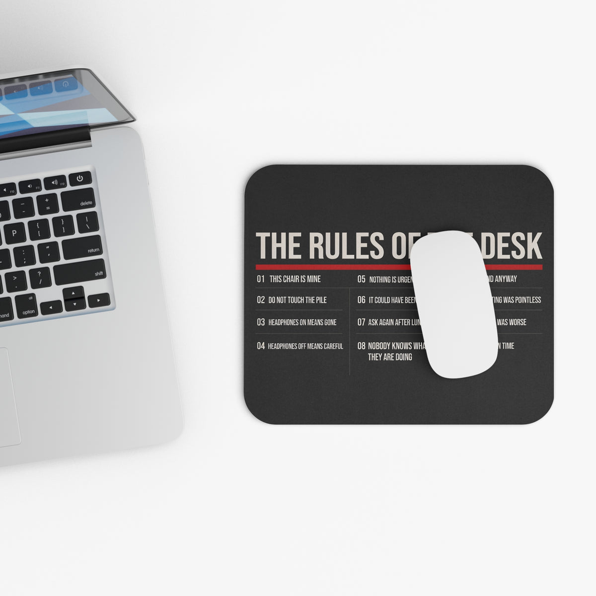 Top view of the rules of the desk mouse pad beside a laptop keyboard