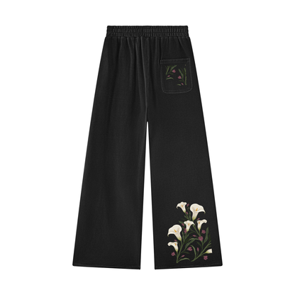 Black calla lily wide leg sweatpants, back view with a small floral sprig on the back pocket