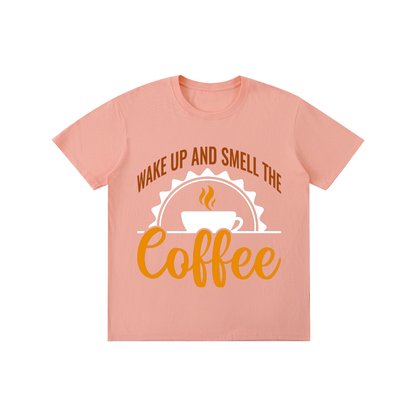 Pink cotton crewneck t-shirt with a rust brown Wake up and smell the coffee design with a white coffee cup and orange cursive Coffee on the front