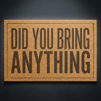 Did You Bring Anything coir doormat with dark lettering on natural tan coir, shown on a dark studio backdrop
