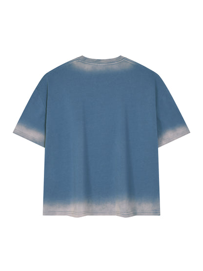 Back view of the boxy sunfade vintage wash t-shirt in jeans blue with a faded hem and sleeves