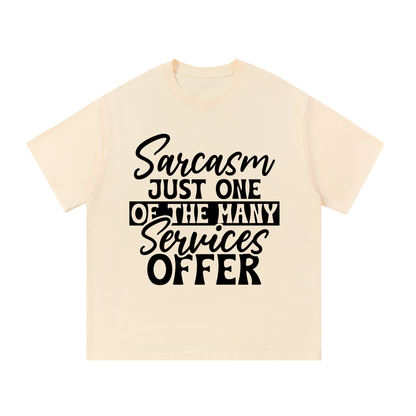 Apricot oversized cotton t-shirt with black cursive and bold capital Sarcasm just one of the many services offer lettering with a black band on the front