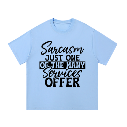 Blue oversized cotton t-shirt with black cursive and bold capital Sarcasm just one of the many services offer lettering with a black band on the front