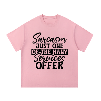 Pink oversized cotton t-shirt with black cursive and bold capital Sarcasm just one of the many services offer lettering with a black band on the front