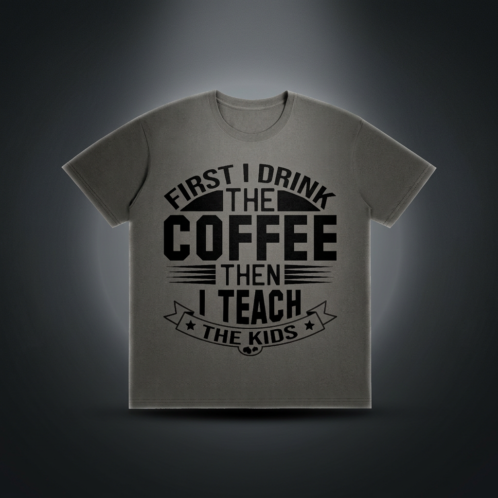 Dark gray cotton crewneck t-shirt with black First I drink the coffee then I teach the kids lettering with a star ribbon banner on the front shown against a dark studio backdrop
