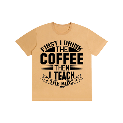 Khaki cotton crewneck t-shirt with black First I drink the coffee then I teach the kids lettering with a star ribbon banner on the front