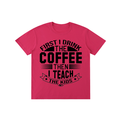 Rose Pink cotton crewneck t-shirt with black First I drink the coffee then I teach the kids lettering with a star ribbon banner on the front