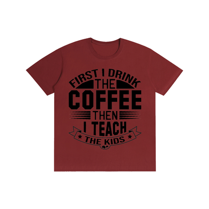 Wine Red cotton crewneck t-shirt with black First I drink the coffee then I teach the kids lettering with a star ribbon banner on the front