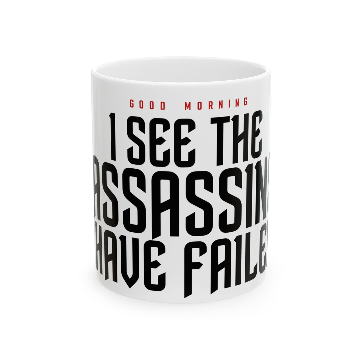 Funny coffee mug printed with "GOOD MORNING / I SEE THE ASSASSINS HAVE FAILED", front view