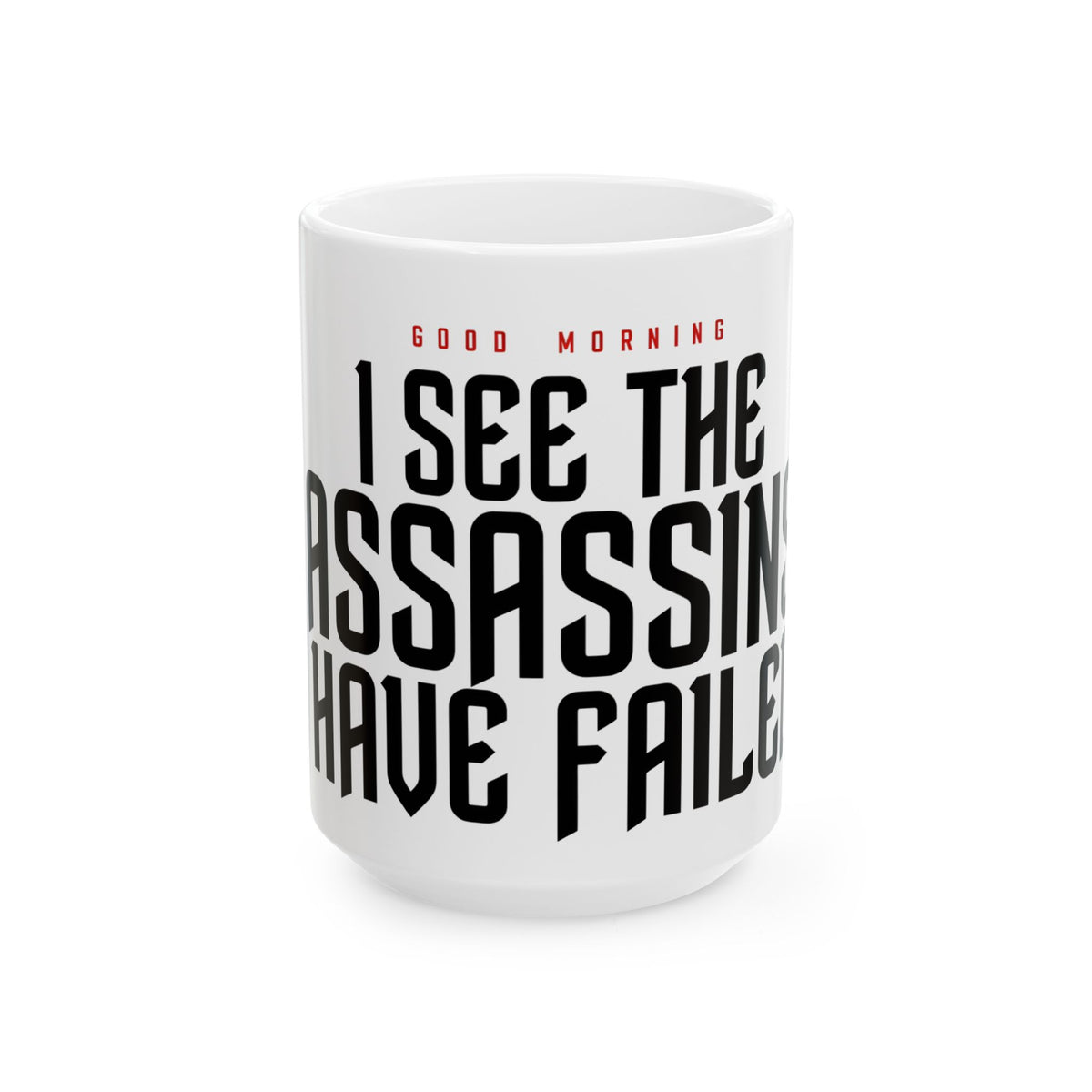 Funny coffee mug printed with "GOOD MORNING / I SEE THE ASSASSINS HAVE FAILED", three-quarter view with the handle on the right