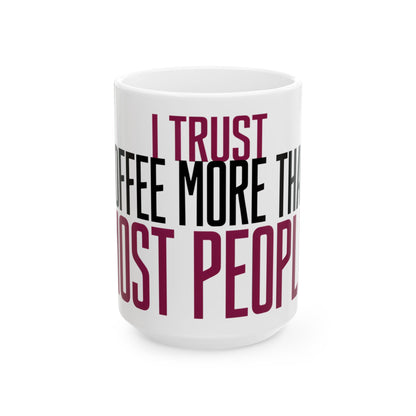 Funny coffee mug printed with "I TRUST COFFEE MORE THAN MOST PEOPLE", three-quarter view with the handle on the right