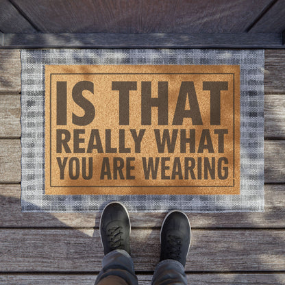 Is That Really What You Are Wearing coir doormat on a wooden porch seen from above with a pair of shoes at the edge