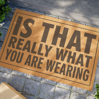 Close view of the Is That Really What You Are Wearing coir doormat on a stone patio in dappled sunlight