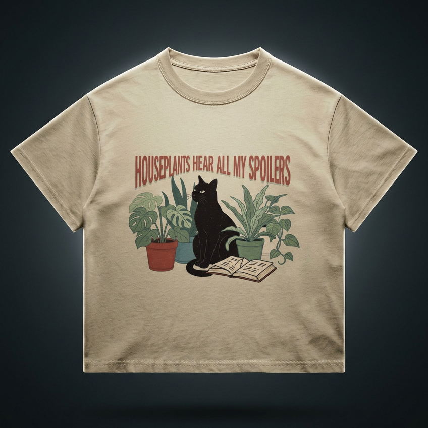 Kids’ loose-fit drop-shoulder tee with a black cat beside houseplants and an open book, Houseplants Hear All My Spoilers front print