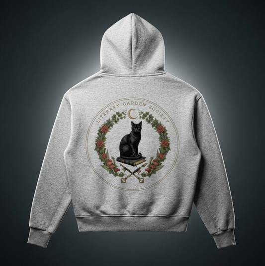Back of a kids’ gray fleece hoodie with a Literary Garden Society seal of a black cat on a book framed by ivy, roses and mushrooms