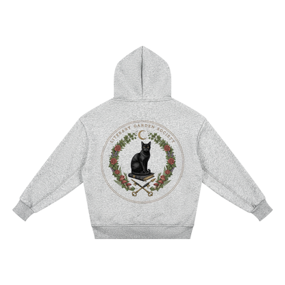 Flat view of the kids’ gray fleece hoodie back print, a black cat on a book with crossed quills and keys, Literary Garden Society