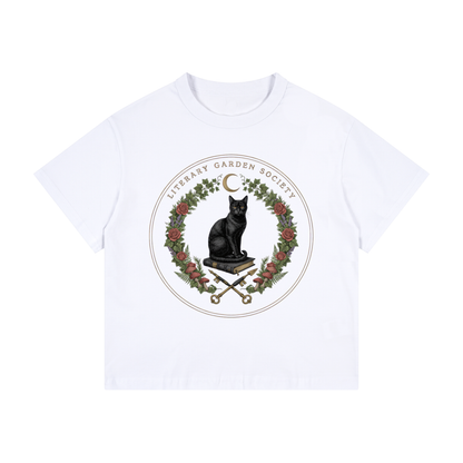 Kids’ Literary Garden Society Loose Fit T-Shirt in white with the black cat and roses crest, front print
