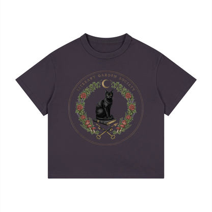 Kids’ Literary Garden Society Loose Fit T-Shirt in dark purple with the black cat and roses crest, front print