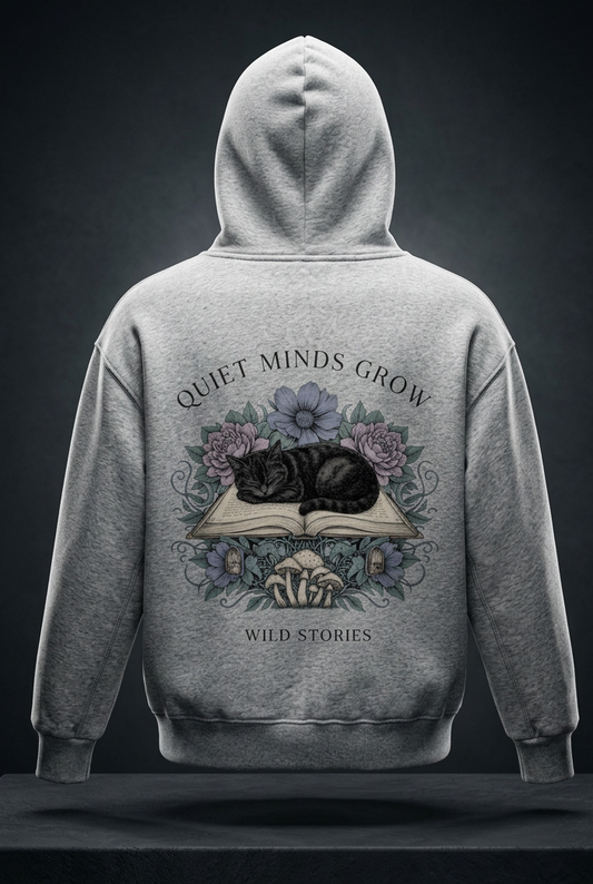 Kids’ fleece hoodie with a sleeping black cat on an open book among flowers, Quiet Minds Grow, Wild Stories back print