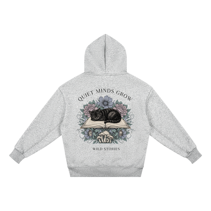 Kids’ fleece hoodie with a sleeping black cat on an open book among flowers, Quiet Minds Grow, Wild Stories back print