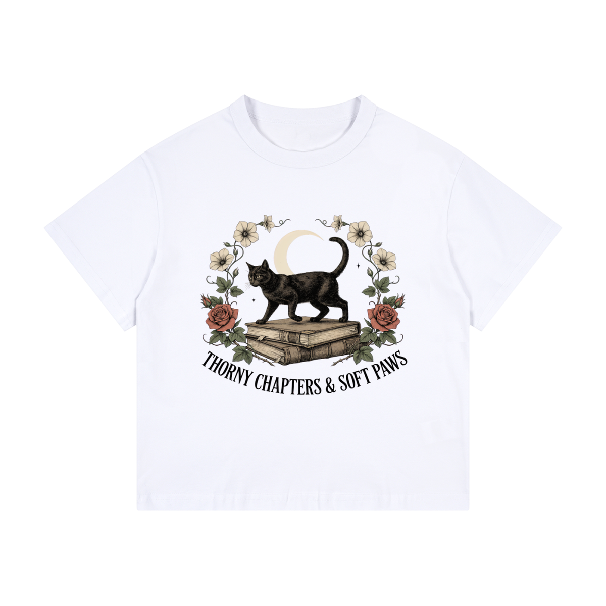 Kids’ loose-fit drop-shoulder tee with a black cat walking over old books under a crescent moon, Thorny Chapters & Soft Paws front print