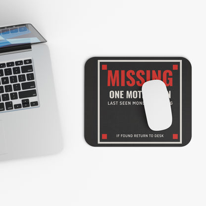 Top view of the missing motivation mouse pad beside a laptop keyboard