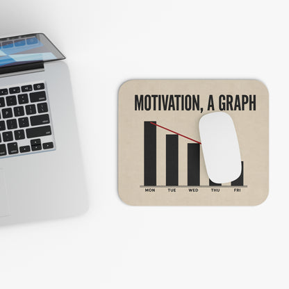 Top view of the motivation graph mouse pad beside a laptop keyboard