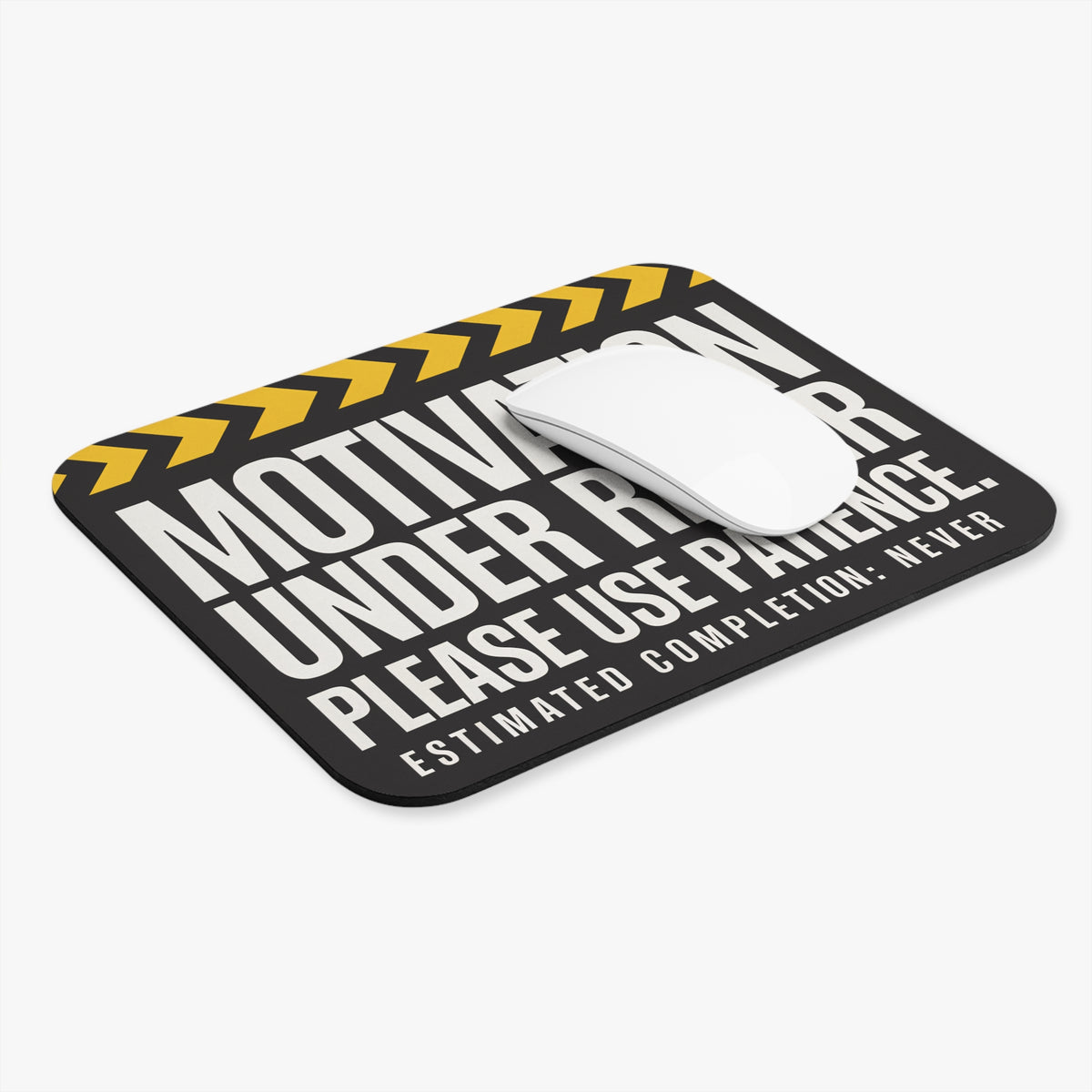 Motivation under repair mouse pad at an angle with a white computer mouse