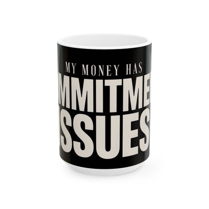 Funny coffee mug printed with "MY MONEY HAS COMMITMENT ISSUES", three-quarter view with the handle on the right