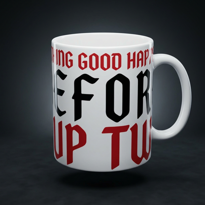 Funny coffee mug printed with "NOTHING GOOD HAPPENS BEFORE CUP TWO", shown on a dark studio background