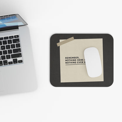 Top view of the nothing is urgent mouse pad beside a laptop keyboard