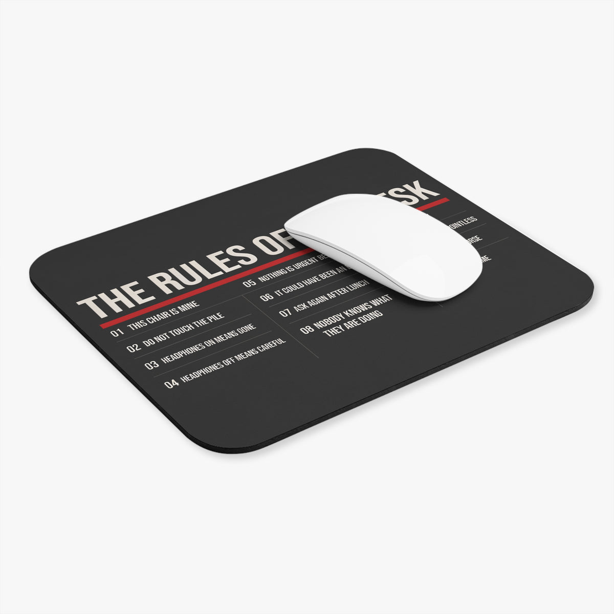Rules of the desk mouse pad at an angle with a white computer mouse