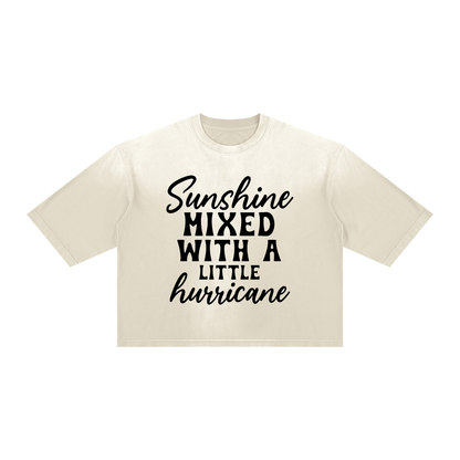 Apricot sunfade boxy t-shirt with black cursive and bold capital Sunshine mixed with a little hurricane quote on the chest
