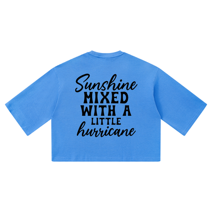 Colourful Blue waffle knit boxy t-shirt with black cursive and bold capital Sunshine mixed with a little hurricane lettering on the back