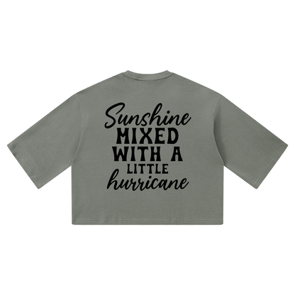 Gray waffle knit boxy t-shirt with black cursive and bold capital Sunshine mixed with a little hurricane lettering on the back