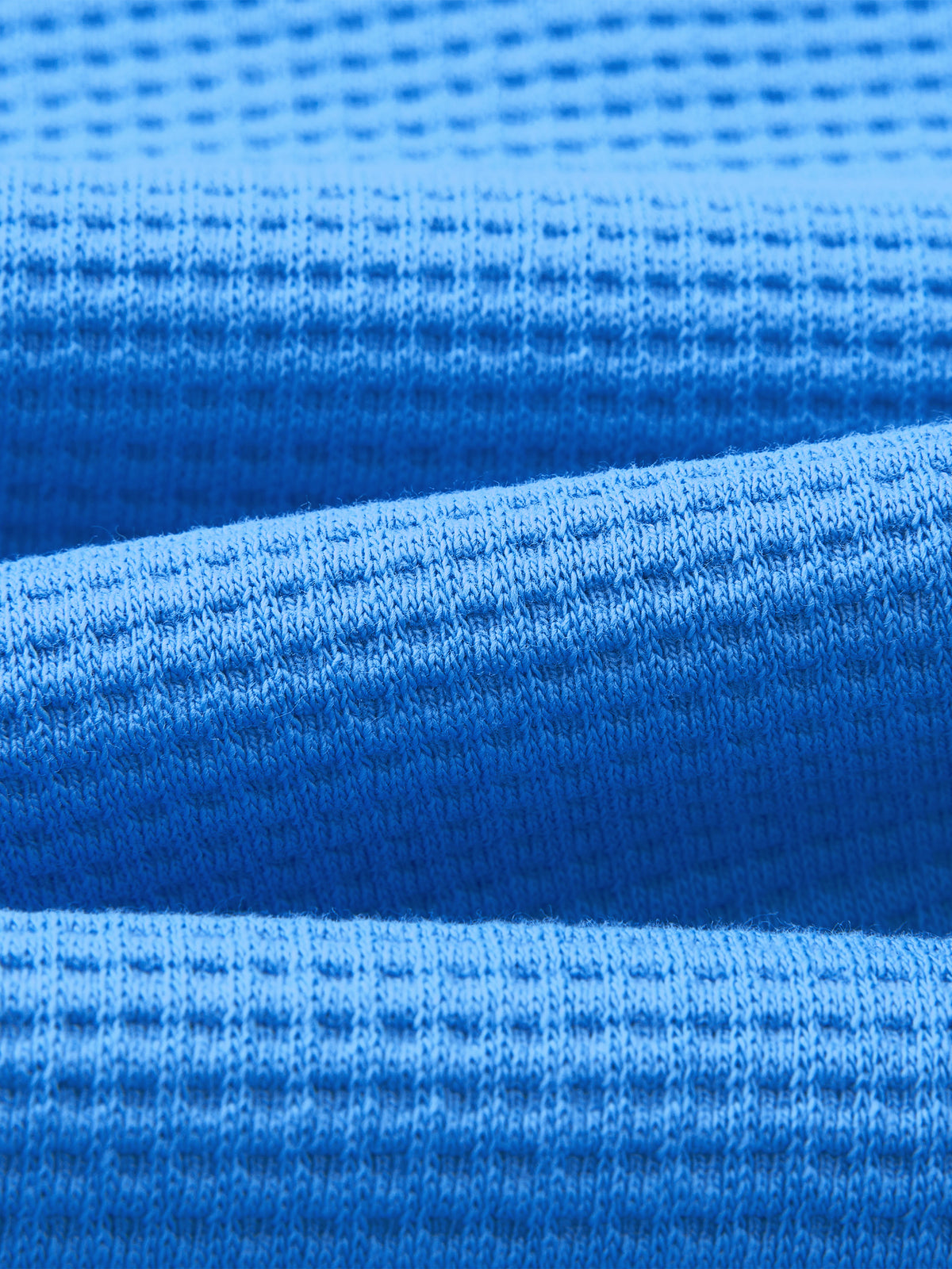 Close-up of the blue waffle knit fabric texture of the boxy t-shirt