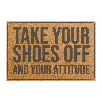 Top view of the Take Your Shoes Off and Your Attitude coir doormat, dark lettering inside a thin border on natural tan fiber