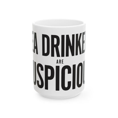 Funny tea mug printed with "TEA DRINKERS ARE SUSPICIOUS", three-quarter view with the handle on the right