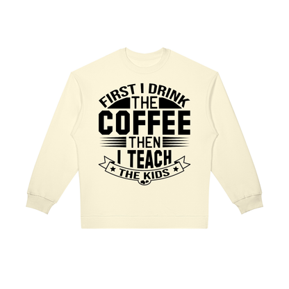 Apricot oversized crewneck sweatshirt with black First I drink the coffee then I teach the kids lettering with a star ribbon banner on the front