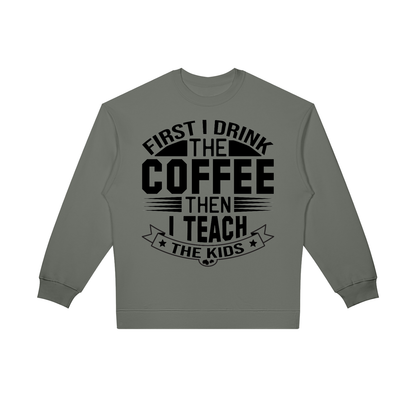 Gray oversized crewneck sweatshirt with black First I drink the coffee then I teach the kids lettering with a star ribbon banner on the front