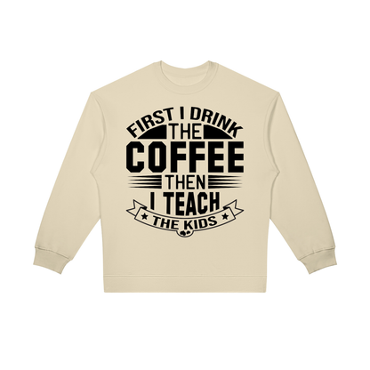 Light Camel oversized crewneck sweatshirt with black First I drink the coffee then I teach the kids lettering with a star ribbon banner on the front