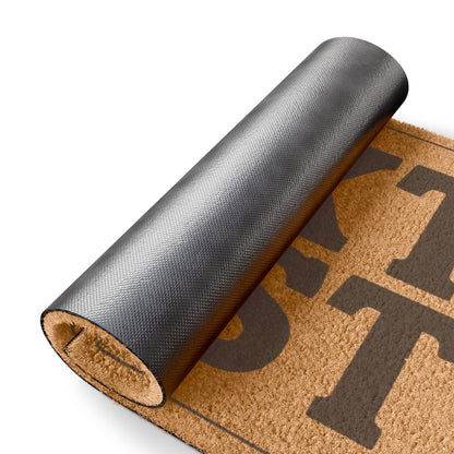 Rolled-up corner of the Text First coir doormat showing the black vinyl backing