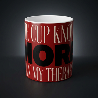 Funny coffee mug printed with "THE CUP KNOWS MORE THAN MY THERAPIST", shown on a dark studio background