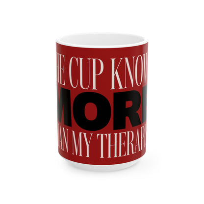 Funny coffee mug printed with "THE CUP KNOWS MORE THAN MY THERAPIST", three-quarter view with the handle on the right