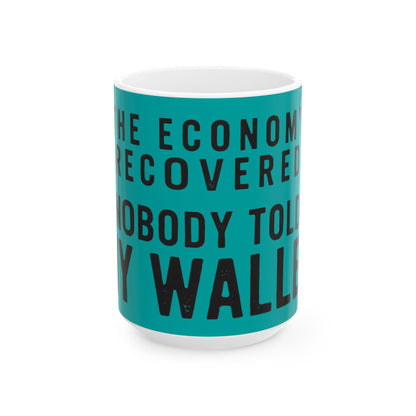 Funny coffee mug printed with "THE ECONOMY RECOVERED NOBODY TOLD MY WALLET", three-quarter view with the handle on the right