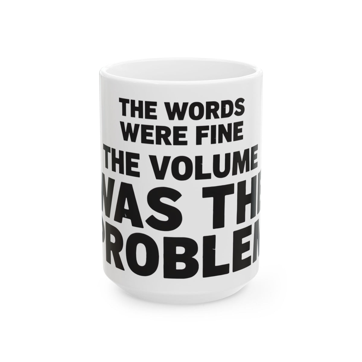 Funny coffee mug printed with "THE WORDS WERE FINE THE VOLUME WAS THE PROBLEM", three-quarter view with the handle on the right