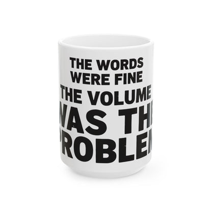 Funny coffee mug printed with "THE WORDS WERE FINE THE VOLUME WAS THE PROBLEM", three-quarter view with the handle on the right