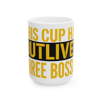 Funny coffee mug printed with "THIS CUP HAS OUTLIVED THREE BOSSES", three-quarter view with the handle on the right