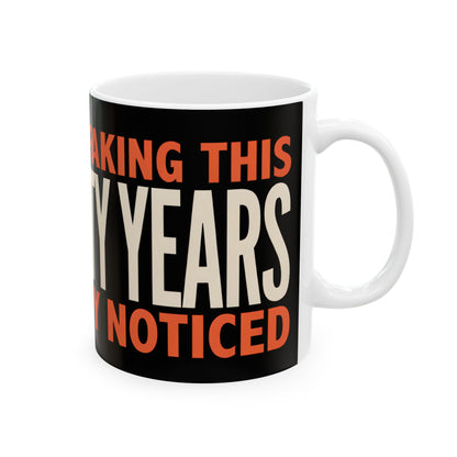 Funny coffee mug printed with "I HAVE BEEN FAKING THIS FOR TWENTY YEARS AND NOBODY NOTICED", right side view