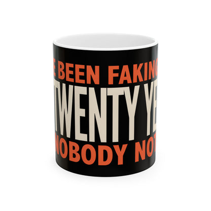 Funny coffee mug printed with "I HAVE BEEN FAKING THIS FOR TWENTY YEARS AND NOBODY NOTICED", three-quarter view with the handle on the right